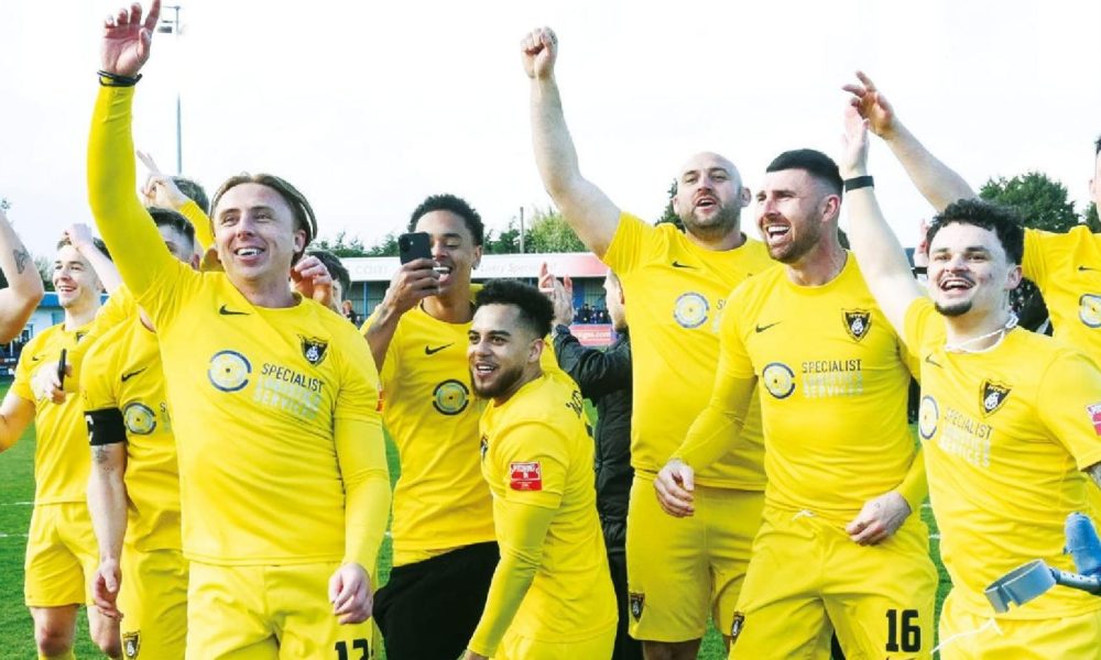 Harborough Town players celebrate the title and promotion