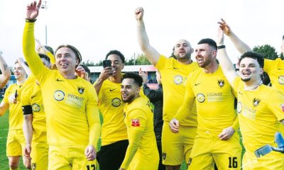 Harborough Town players celebrate the title and promotion