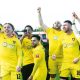 Harborough Town players celebrate the title and promotion