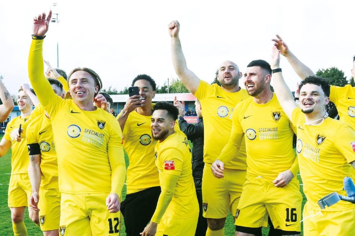 Harborough Town players celebrate the title and promotion