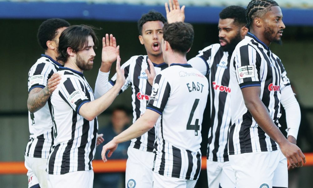 Rochdale players celebrate Aidan Barlow’s opener before the stoppage-time pandemonium