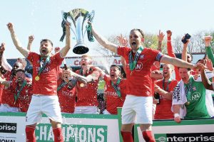 York City’s Ollie Pearce, left, and Callum Howe hoist the trophy high
